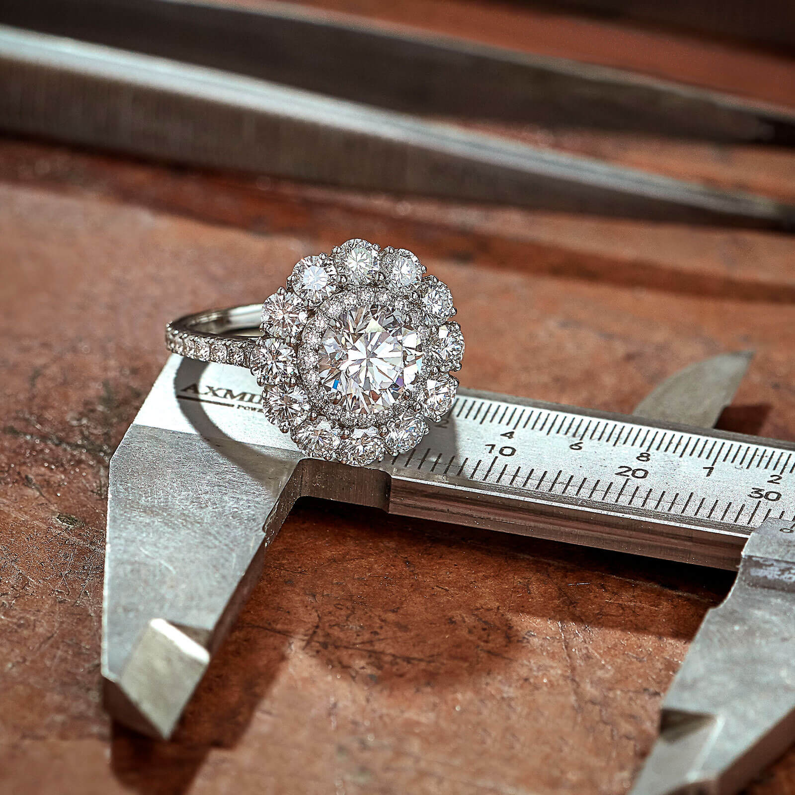 The Garrard Harmony Round Brilliant Diamond Double Cluster Engagement Ring In Platinum with Diamondsin the workshop square