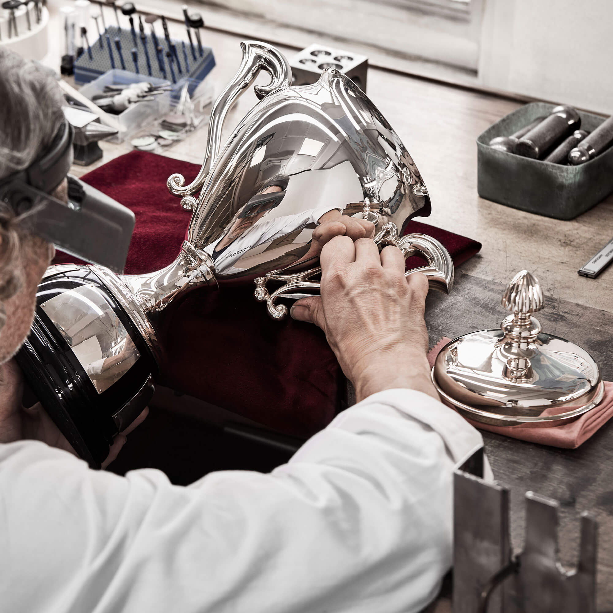 a silver garrard sporting trophy being polished by a mastercraftsman
