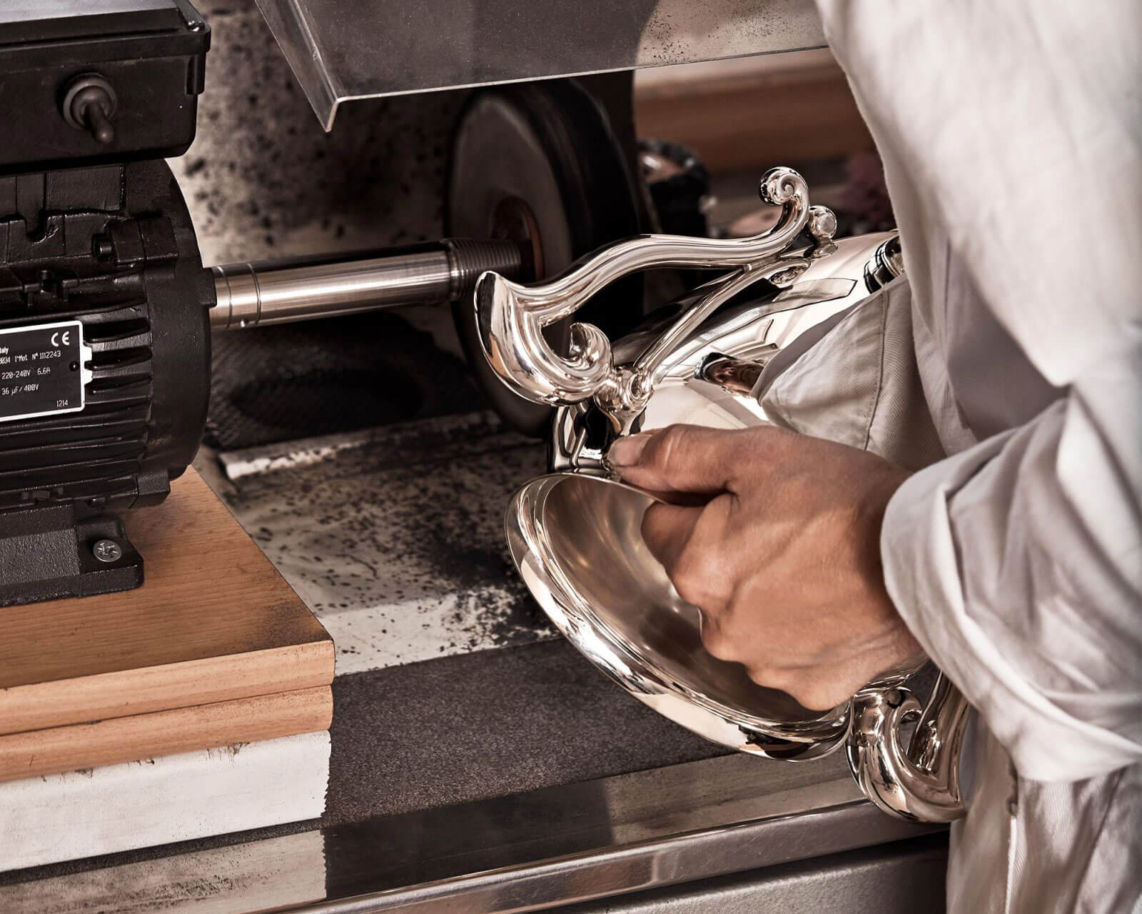 a Garrard silversmith polishing a new trophy in the Garrard workshop 1600x2000 desktop