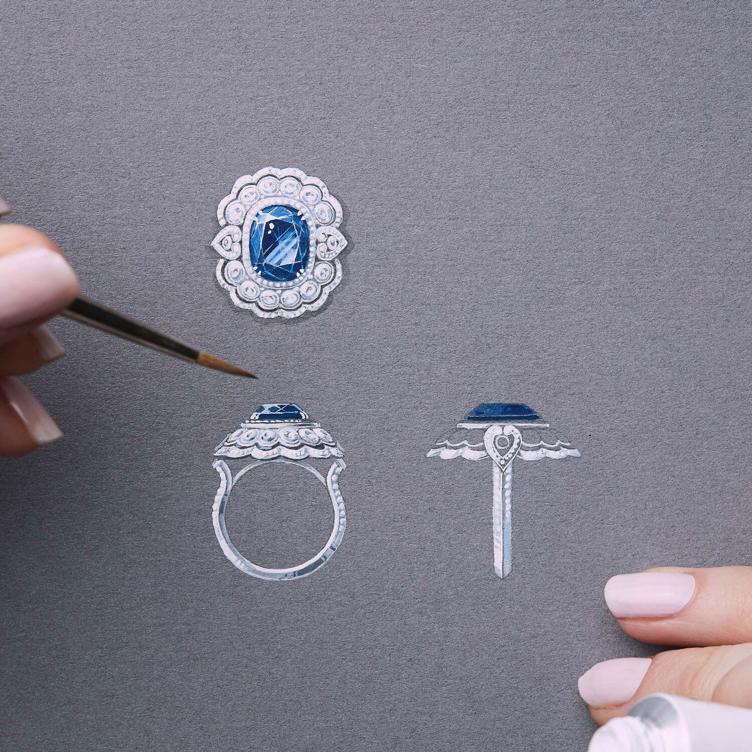 a Garrard jewellery designer skethcing a bespoke sapphire Garrard engagement ring on gouache paper square