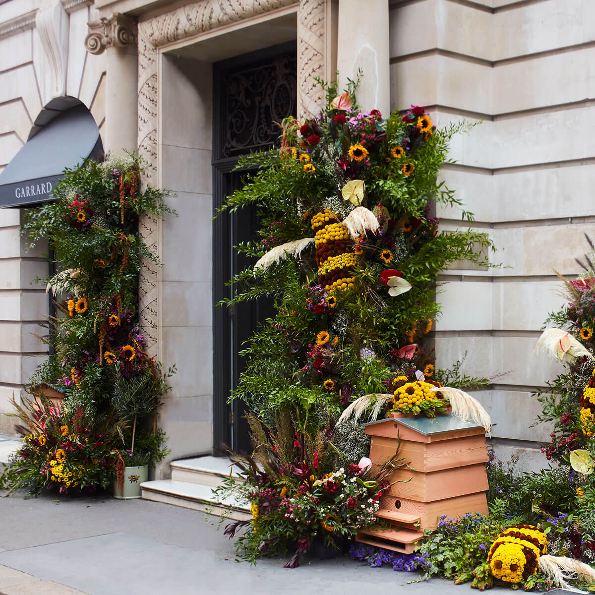 Entrance of the Garrard London Flagship jewellery boutique with flowers and a bee house to support sustainability