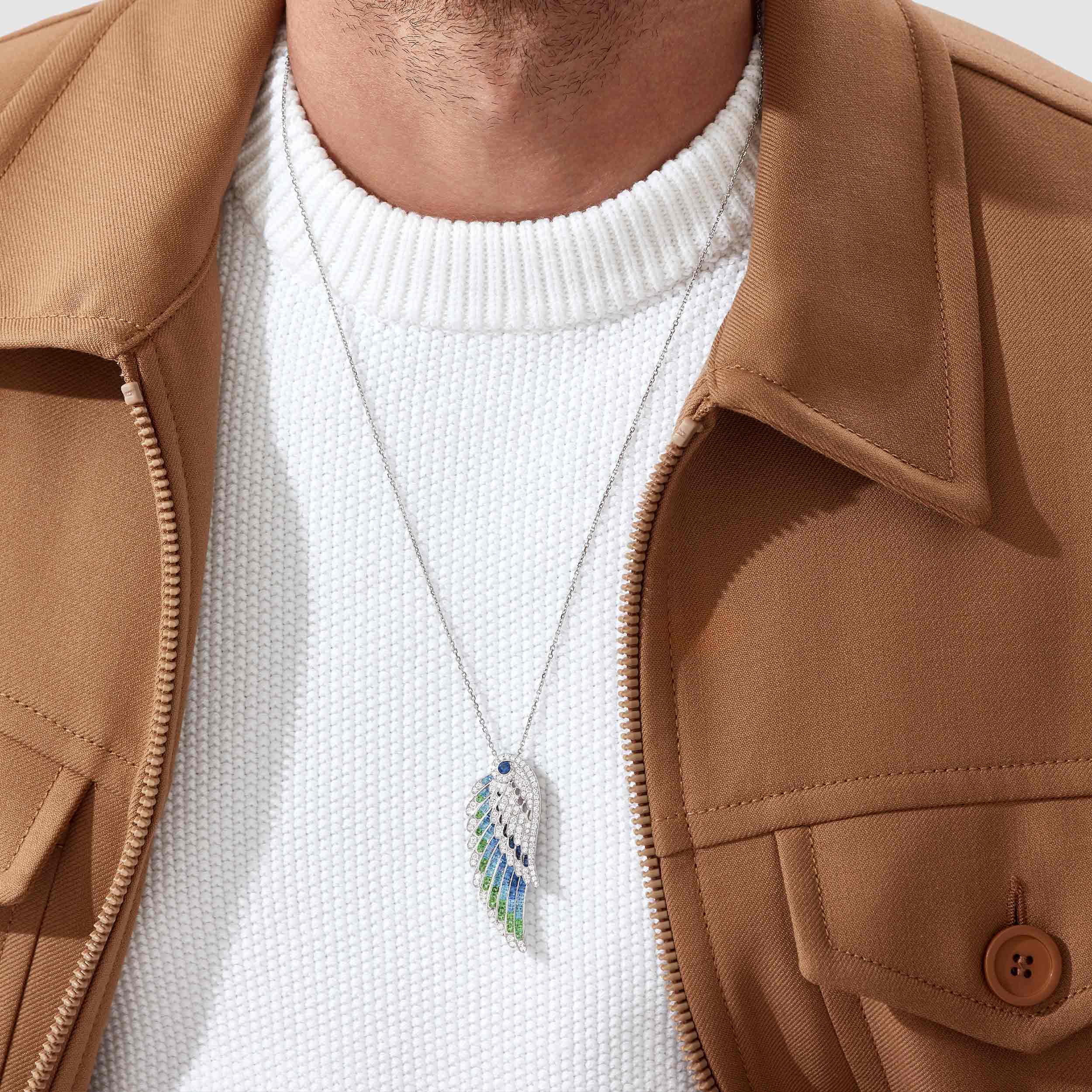 Garrard Wings Embrace collection Peacock Slide Pendant with Diamonds Sapphires Tsavorites and Aquamarines 2017610 male model Garrard Wings Embrace collection Peacock Slide Pendant with Diamonds Sapphires Tsavorites and Aquamarines 2017610 male model