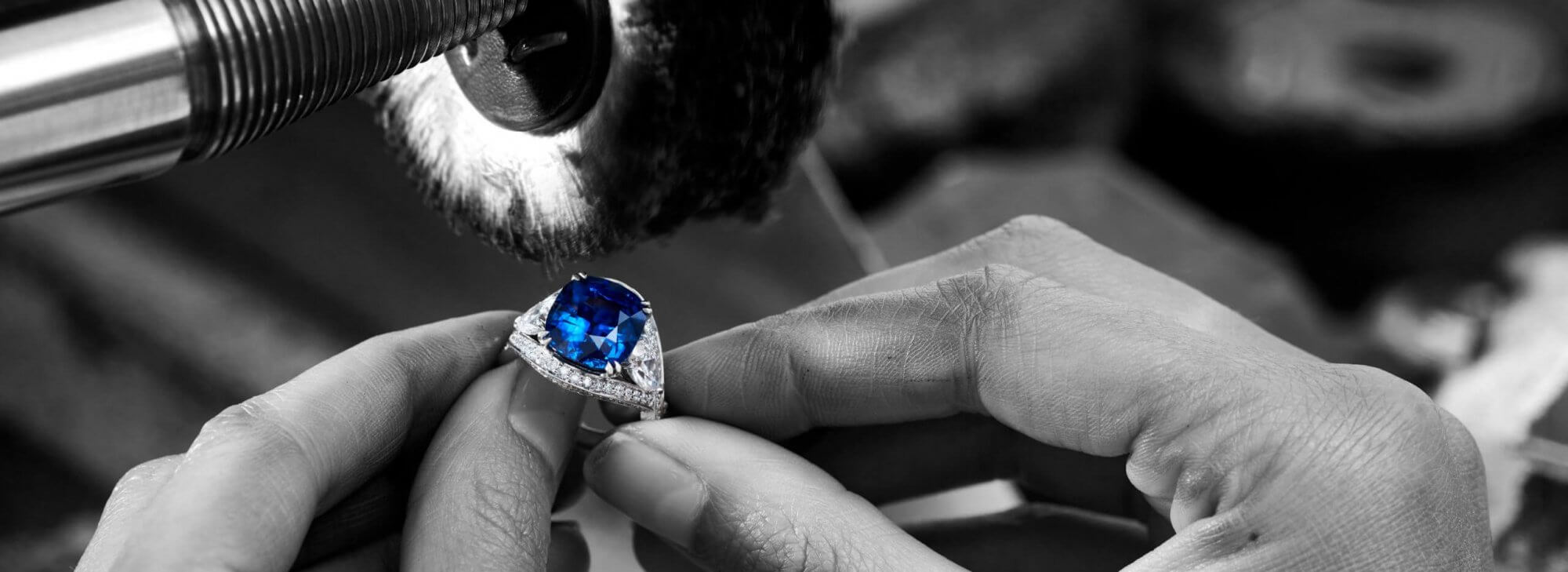 a craftsman repairing a Garrard Jewelled Vault Sapphire and diamond ringin the workshop desktop