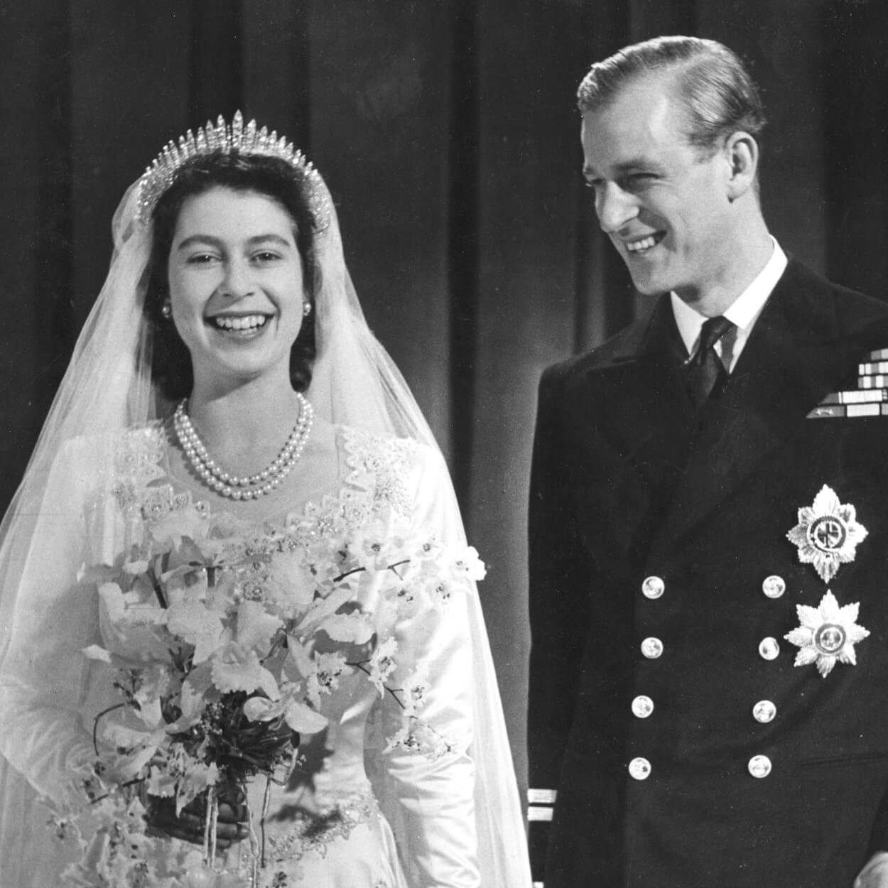 Queen Elizabeth wearing the Fringe Tiara made by Garrard standing with Prince Phillip