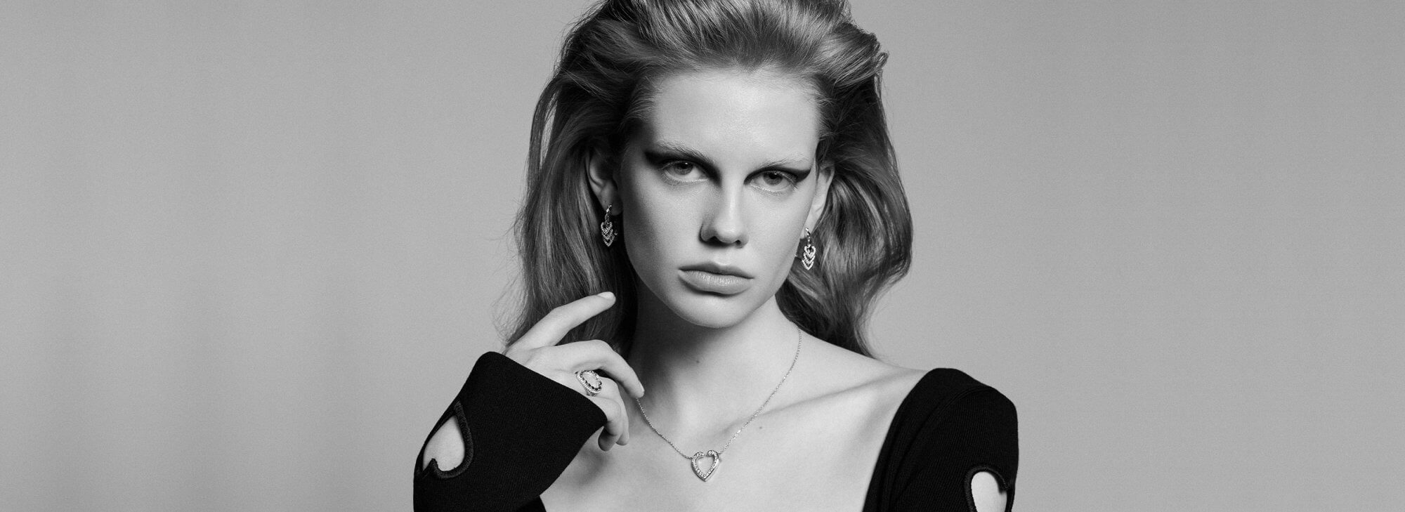 Model wears Garrard Aloria Jewellery Collection earrings ring and pendant desktop