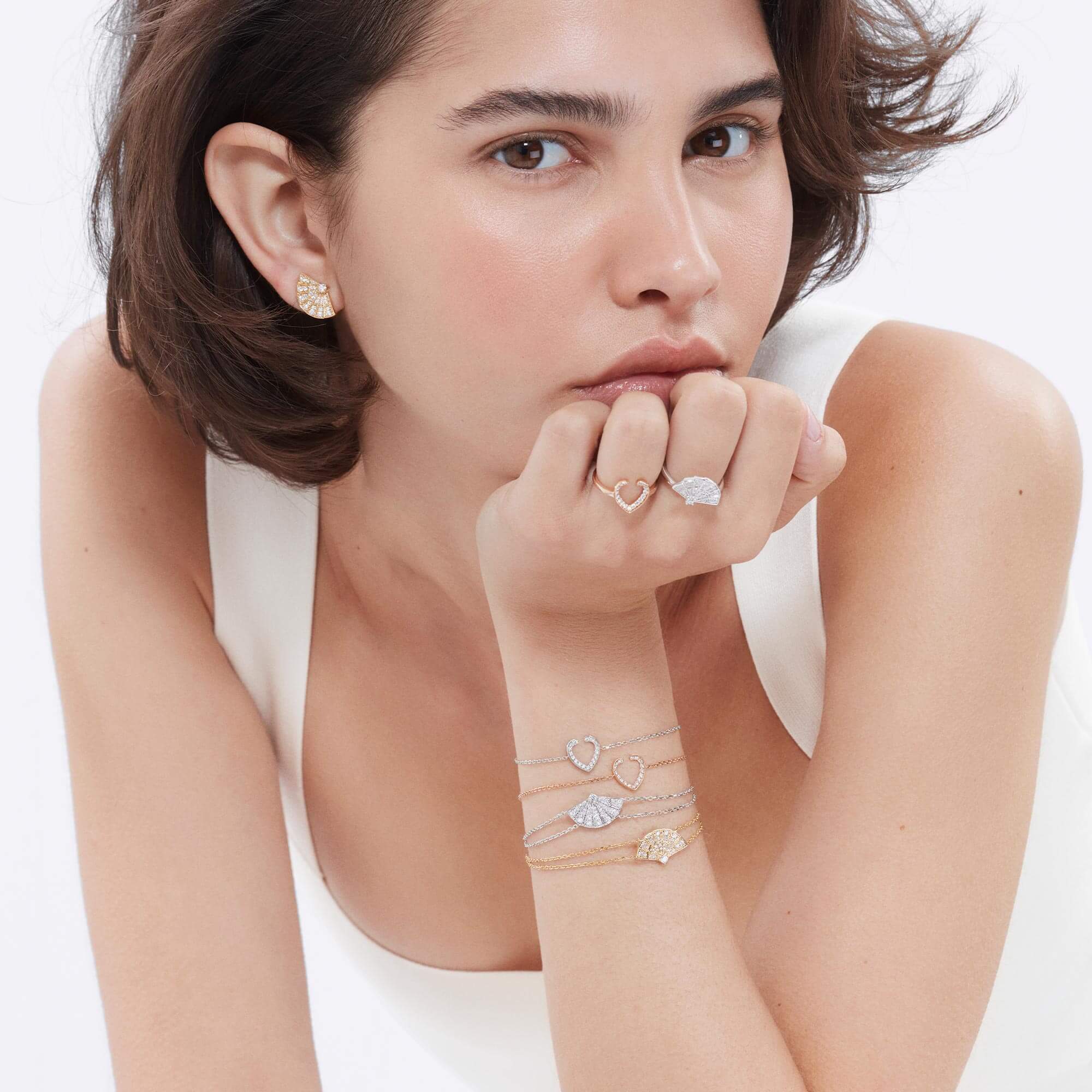 Model wears Garrard Fanfare and Aloria Mini Icons diamond jewellery close up