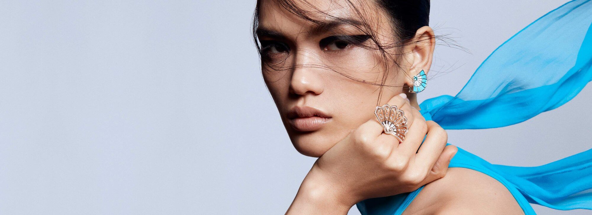 Model wears Garrard Fanfare Jewellery Collection earrings and ring desktop coloured