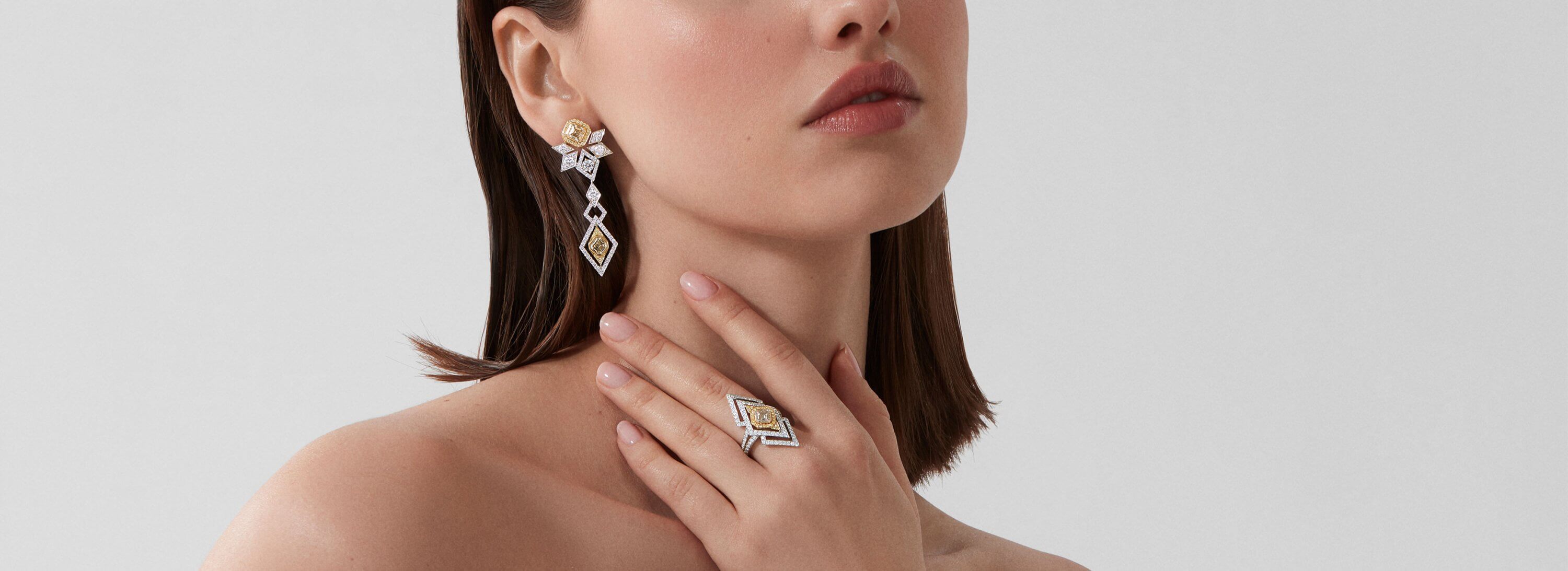 Model wears Garrard Cosmos High Jewellery Yellow and White Diamond earrings and ring desktop