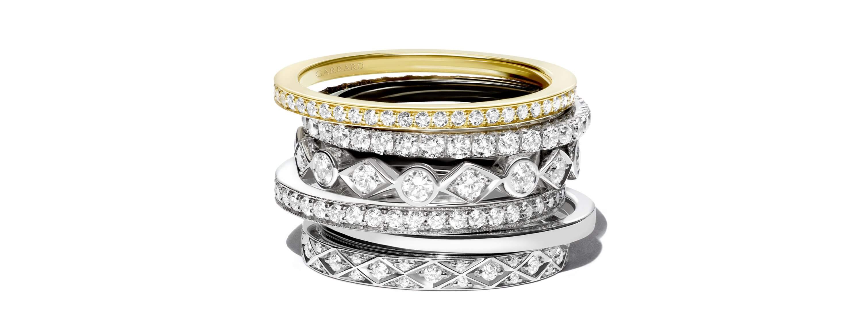 A stack of Garrard diamond wedding bands and eternity rings wedding bands landing page